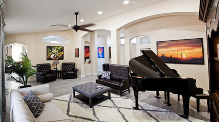 Shared living room with piano at Norterra Assisted Living.
